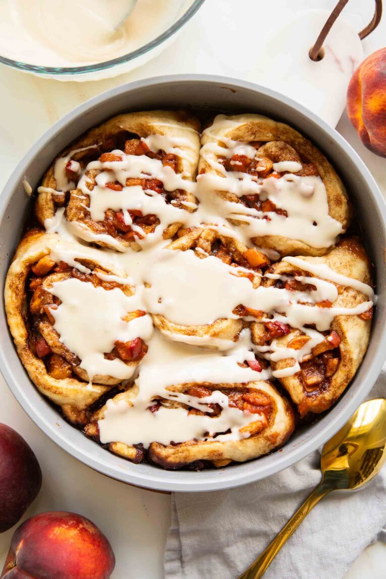 Brown Sugar Peach Cinnamon rolls in a baking pan.