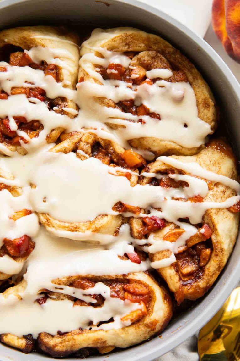 Brown Sugar Peach Cinnamon rolls in a baking pan.