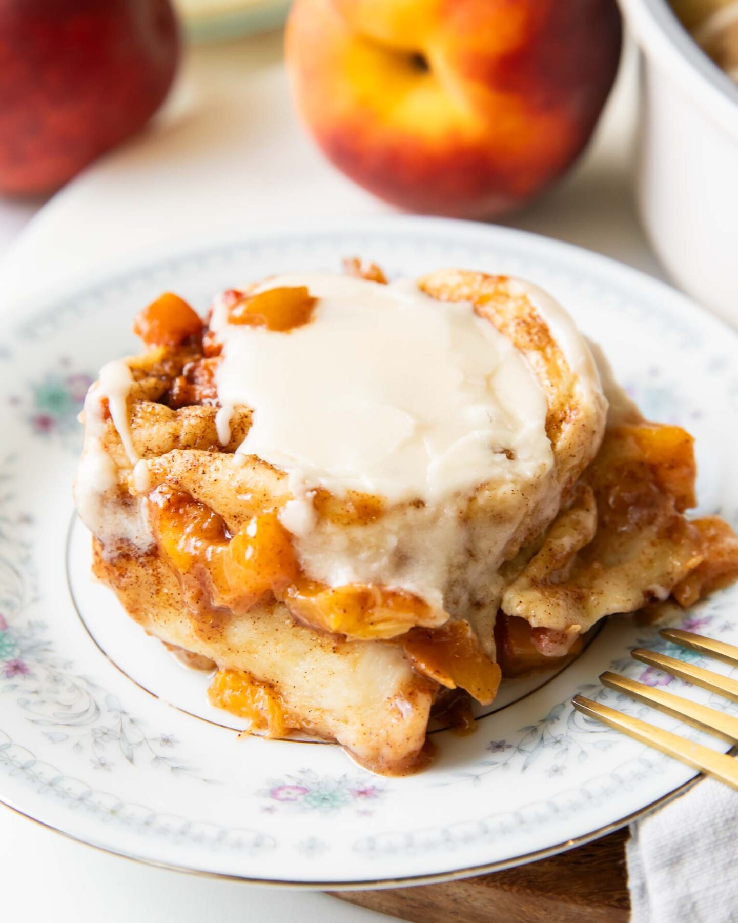 Brown Sugar Peach Cinnamon roll on a plate.