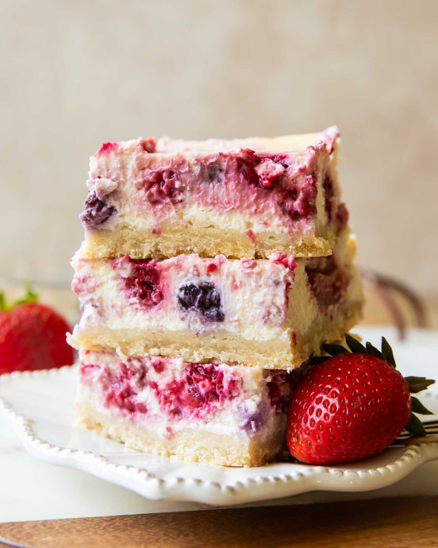 Greek Yogurt Cheesecake bars stacked on top of each other.