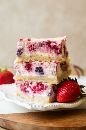 Greek Yogurt Cheesecake bars stacked on top of each other.