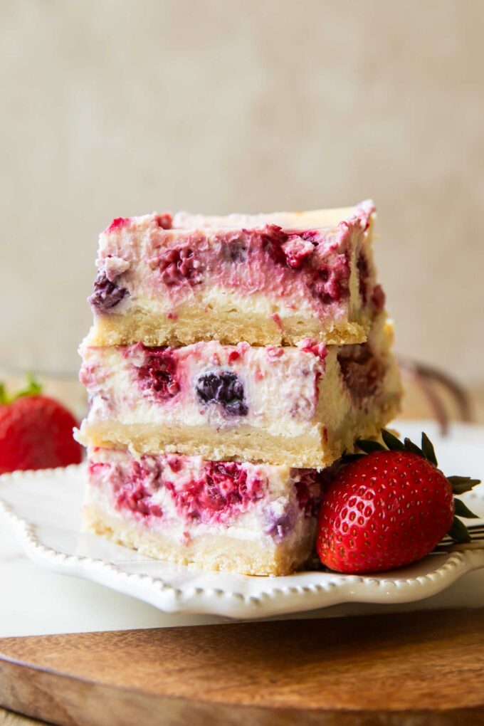 Greek Yogurt Cheesecake bars stacked on top of each other.
