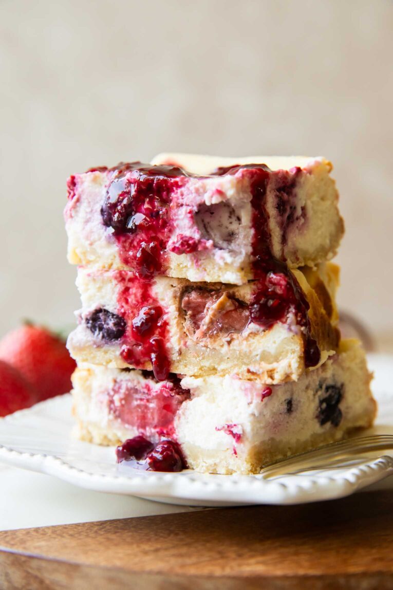Greek Yogurt Cheesecake bars stacked on top of each other.