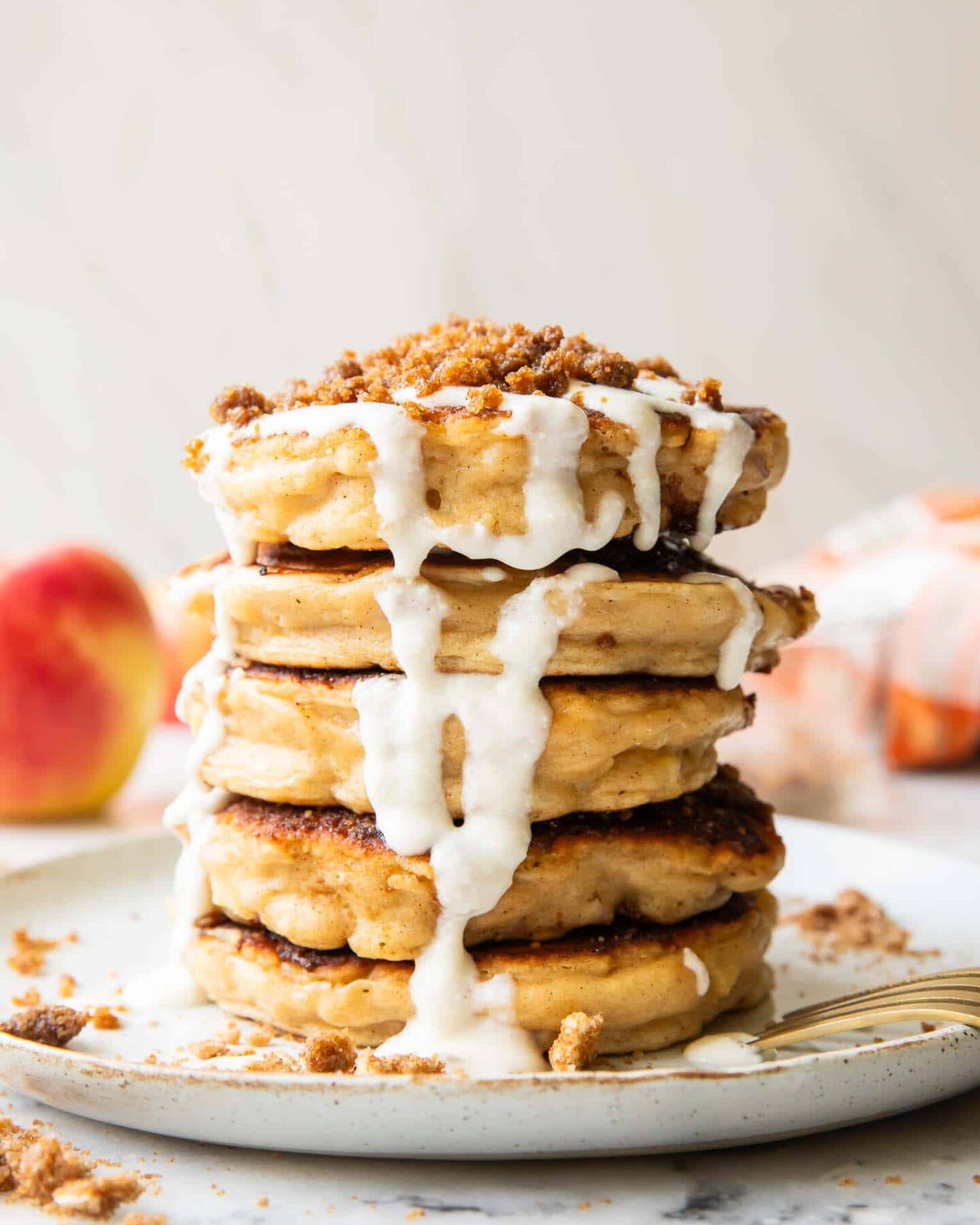 A stack of apple struesel pancakes on a plate.