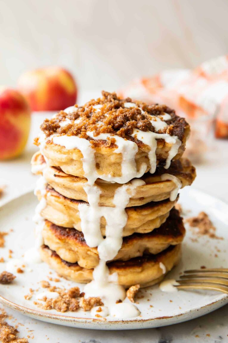 A stack of apple struesel pancakes on a plate.