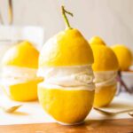 Limoncello Ice Cream in between two lemons.