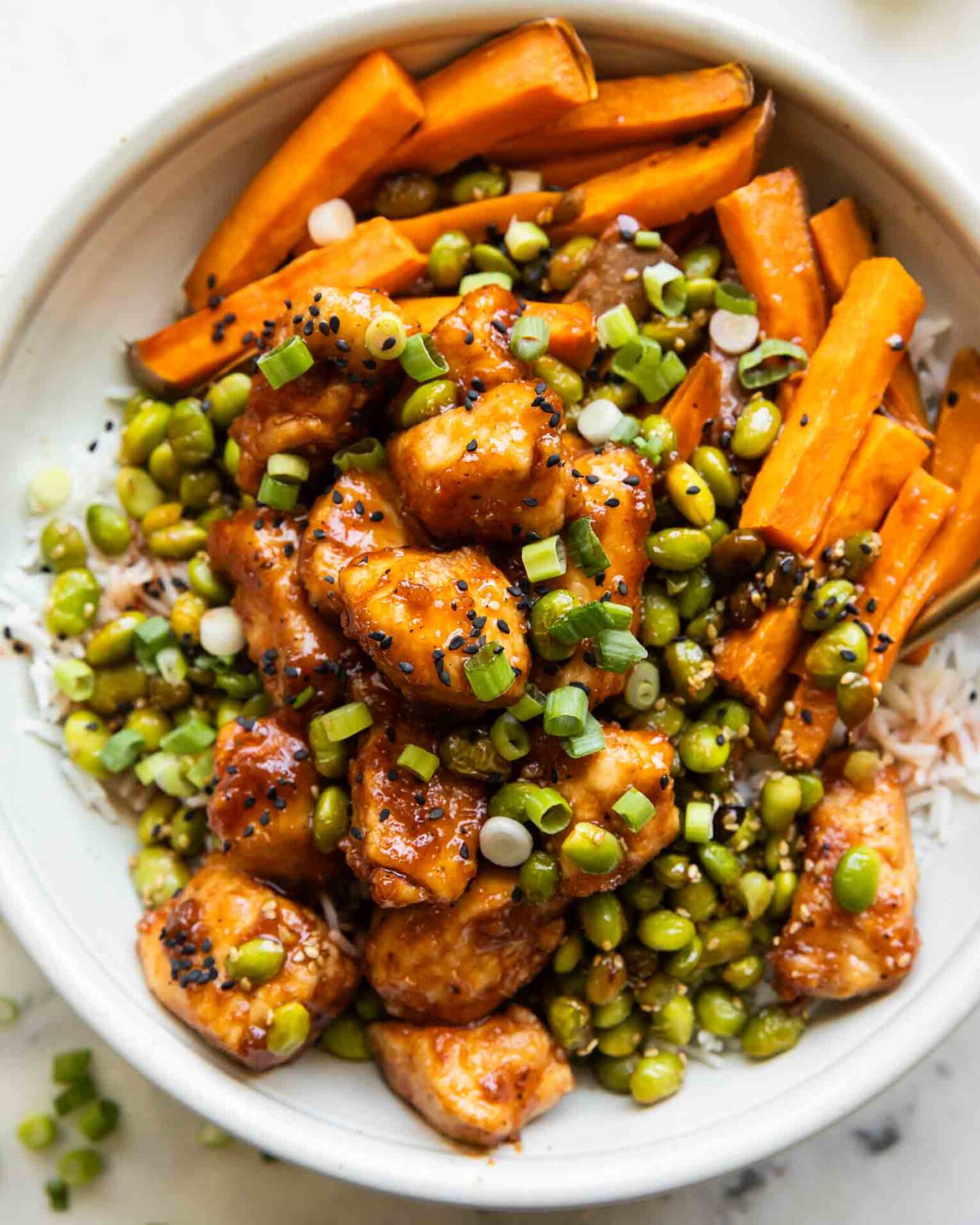 Sticky Sriracha Honey Chicken in a bowl.